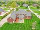 Back aerial view showcasing patio, lawn, and mature trees surrounding the property at 1902 Windmere Dr, Monroe, NC 28110