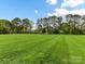 Expansive green backyard features level terrain and mature trees at 1902 Windmere Dr, Monroe, NC 28110