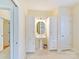 Bright bathroom featuring a vanity with sink, linen closets, and two doors at 1902 Windmere Dr, Monroe, NC 28110