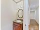 Bathroom features a stylish vanity with a granite countertop and an oval mirror at 1902 Windmere Dr, Monroe, NC 28110