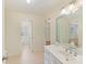 Bathroom vanity with bright lighting and a view to the bedroom at 1902 Windmere Dr, Monroe, NC 28110