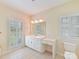 Bright bathroom with a vanity and sink, complemented by natural light from two windows at 1902 Windmere Dr, Monroe, NC 28110