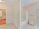 Bright bathroom featuring a tub and a walk-in closet at 1902 Windmere Dr, Monroe, NC 28110