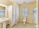 Bathroom featuring tile floors, built-in linen cabinet, and shower-tub combo at 1902 Windmere Dr, Monroe, NC 28110