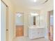 Bathroom vanity with white cabinets and a view to the bedroom at 1902 Windmere Dr, Monroe, NC 28110