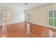 Spacious bedroom featuring hardwood floors, bright windows, and adjoining bathroom at 1902 Windmere Dr, Monroe, NC 28110