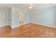 Light-filled bedroom featuring neutral walls, ceiling fan, and hardwood floors at 1902 Windmere Dr, Monroe, NC 28110