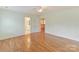 Spacious bedroom with hardwood floors, open doorway with views of the house at 1902 Windmere Dr, Monroe, NC 28110