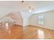 Spacious bonus room with hardwood floors and a large window at 1902 Windmere Dr, Monroe, NC 28110