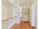 Walk-in closet featuring hardwood floors and custom shelving at 1902 Windmere Dr, Monroe, NC 28110