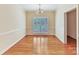 A well-lit dining room with hardwood floors and a large window overlooking the yard at 1902 Windmere Dr, Monroe, NC 28110
