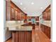 Spacious kitchen features wood cabinets, center island, hardwood floors and ample counter space at 1902 Windmere Dr, Monroe, NC 28110