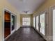 A bright sunroom features tile flooring, lots of windows, and french doors at 1902 Windmere Dr, Monroe, NC 28110