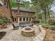 Secluded brick patio featuring a fire pit, garden area, and an outdoor seating area at 2313 Beechwood Dr, Waxhaw, NC 28173