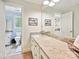 Bright bathroom featuring a granite vanity and a view into another bathroom through a doorway at 2313 Beechwood Dr, Waxhaw, NC 28173