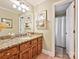 Bathroom featuring a granite countertop, a wood vanity, and a view to a shower over tub at 2313 Beechwood Dr, Waxhaw, NC 28173