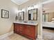 Bathroom featuring a wood vanity with double sinks, chrome fixtures, and an adjacent bedroom at 2313 Beechwood Dr, Waxhaw, NC 28173