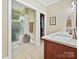 Bright bathroom featuring a frameless glass shower, marble-look countertop, and view to a closet at 2313 Beechwood Dr, Waxhaw, NC 28173