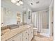 Well-lit bathroom featuring a vanity with granite counters, a shower-tub combination, and neutral-colored walls at 2313 Beechwood Dr, Waxhaw, NC 28173