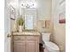 Well-lit half bathroom featuring granite countertops and modern fixtures at 2313 Beechwood Dr, Waxhaw, NC 28173