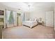 Inviting primary bedroom with ample natural light, neutral décor, and a comfortable bed at 2313 Beechwood Dr, Waxhaw, NC 28173