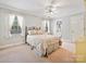 Bright bedroom with windows, carpet, and a glimpse into an adjacent bathroom through an open doorway at 2313 Beechwood Dr, Waxhaw, NC 28173