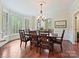 Bright dining room featuring hardwood floors, large windows, and an elegant chandelier at 2313 Beechwood Dr, Waxhaw, NC 28173