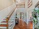 Grand two-story foyer with hardwood floors, staircase, and an open view at 2313 Beechwood Dr, Waxhaw, NC 28173