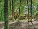 Charming brick home featuring mature trees, a landscaped front yard, and elegant architectural details at 2313 Beechwood Dr, Waxhaw, NC 28173