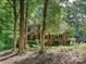 Brick home featuring mature trees, a landscaped front yard, and elegant architectural details at 2313 Beechwood Dr, Waxhaw, NC 28173