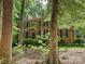 Charming brick home featuring mature trees, a landscaped front yard, and elegant architectural details at 2313 Beechwood Dr, Waxhaw, NC 28173
