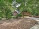 Brick home with an attached garage and a long driveway through mature trees and lush greenery at 2313 Beechwood Dr, Waxhaw, NC 28173
