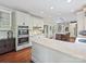 Well-designed kitchen with an island, white cabinetry, and hardwood flooring at 2313 Beechwood Dr, Waxhaw, NC 28173