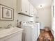 Practical laundry room with a utility sink, washer, dryer, and ample storage space at 2313 Beechwood Dr, Waxhaw, NC 28173