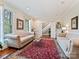 Inviting living room with a decorative rug, large windows, and access to the upper floor at 2313 Beechwood Dr, Waxhaw, NC 28173