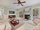 Spacious living room featuring a TV, neutral tones, fireplace, and glass doors to the outside at 2313 Beechwood Dr, Waxhaw, NC 28173