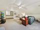Large bonus room with a television, ample seating, and a ceiling fan for comfort at 2313 Beechwood Dr, Waxhaw, NC 28173