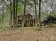 Brick house with green shutters and meticulously maintained landscaping surrounded by mature trees at 2313 Beechwood Dr, Waxhaw, NC 28173