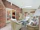 Cozy sunroom featuring a brick wall, skylights, and access to an outdoor space at 2313 Beechwood Dr, Waxhaw, NC 28173