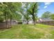 Expansive backyard with lush lawn and wooden fence, surrounded by mature trees at 2414 Remount Rd, Charlotte, NC 28208