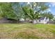 Large, grassy backyard enclosed by a wooden fence, with mature trees and a view of the home at 2414 Remount Rd, Charlotte, NC 28208