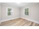 Bright bedroom featuring wood floors and two windows providing natural light at 2414 Remount Rd, Charlotte, NC 28208