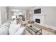 Comfortable living room area with hardwood floors and a fireplace adjacent to the dining area and kitchen at 2414 Remount Rd, Charlotte, NC 28208
