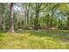 Spacious backyard with mature trees, benches, and a tranquil setting at 252 Stamey Farm Rd, Statesville, NC 28677