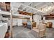 Unfinished basement with exposed ceiling and visible utilities; includes vintage furniture at 252 Stamey Farm Rd, Statesville, NC 28677