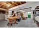 Unfinished basement with vintage furniture, wood ceiling joists, and concrete flooring at 252 Stamey Farm Rd, Statesville, NC 28677