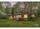 Quaint brick home accented by vibrant landscaping, and features a lovely covered carport for convenience at 252 Stamey Farm Rd, Statesville, NC 28677
