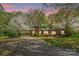 Charming brick home featuring a driveway and lush landscaping in a peaceful and serene setting at 252 Stamey Farm Rd, Statesville, NC 28677