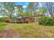 View of the brick home with a sunroom addition and attached carport at 252 Stamey Farm Rd, Statesville, NC 28677