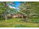 Beautiful exterior of a brick home surrounded by lush greenery and mature trees at 252 Stamey Farm Rd, Statesville, NC 28677